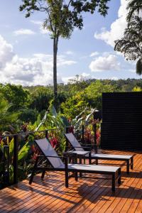 two chairs and a bench on a wooden deck at Arenal Manoa Hot Springs Resort in Fortuna +136 photos