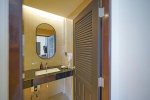 a bathroom with a sink and a mirror at Cape and Sea Resort in Ban Boet +40 photos