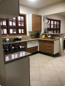 a large kitchen with wooden cabinets and appliances at Rick estadia in São Gabriel
