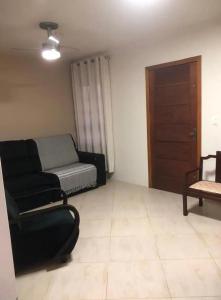 a living room with a couch and a chair at Rick estadia in São Gabriel