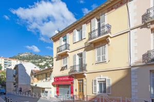 a yellow building with balconies on a street at Monaco Border - Coquet et Authentique - FM in Beausoleil