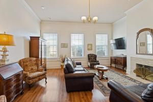a living room with a couch and a fireplace at Grenoble House in New Orleans