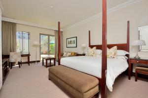 a large bedroom with a large bed and a desk at The Syrene Boutique Hotel in Johannesburg