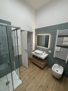 a bathroom with a sink and a toilet and a shower at Notte di note in Pagani