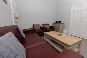 a living room with a couch and a coffee table at Principal Keeper's Cottage at Sumburgh Lighthouse, Shetland Islands in Sumburgh +54 photos