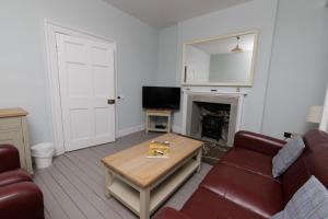 a living room with a couch and a coffee table at Principal Keeper's Cottage at Sumburgh Lighthouse, Shetland Islands in Sumburgh