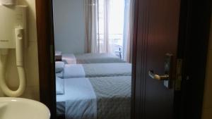 a bathroom with two beds in a hotel room at Tokalis Boutique Hotel & Spa in Nea Anchialos