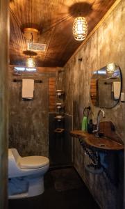a bathroom with a sink and a toilet and a mirror at Pistacho in Minca
