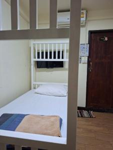 a bedroom with a bunk bed with a ladder at Indy house59 in Bangkok