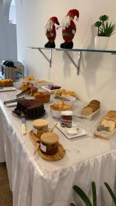 a table topped with lots of different types of food at Hotel Raio de Sol in Guarapari