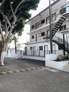 a large white building with a parking lot in front of it at Hotel Del Bosque in Tijuana