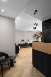 a lobby with a counter and chairs in a room at Collect Residence in Budapest