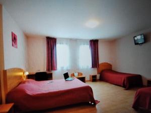 a hotel room with two beds and a desk at Contact Hôtel - Prim Witry - Reims Nord in Reims +23 photos