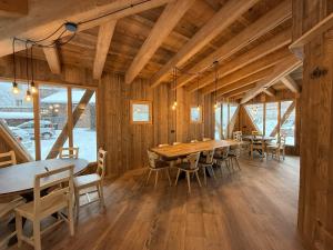 a dining room with a long table and chairs at Hotel Vallechiara in Bormio