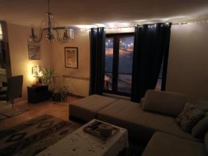a living room with a couch and a window at Apartment Imamović in Vogošća