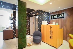 a lobby with a desk and a chair and a sign at TheROOMS by TheFLOOR Collection in Milan