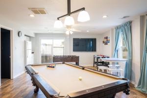 a pool table in a living room with a ceiling at Nags Head Oceanfront Private Beach Access & Pool in Nags Head