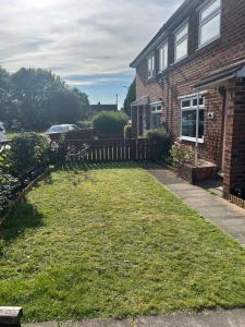 a yard in front of a house with a fence at Conner house in Middlesbrough
