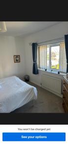 a bedroom with a white bed and a window at Conner house in Middlesbrough