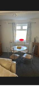 a dining room with a table and chairs and a window at Conner house in Middlesbrough