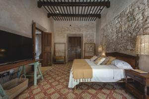 a bedroom with a bed and a flat screen tv at Luxury Suite by La Casa Verde in Campeche +10 photos