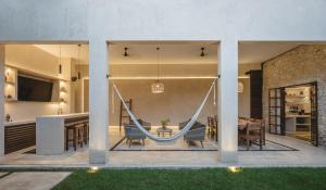 a hammock in the living room of a house at Luxury Suite by La Casa Verde in Campeche