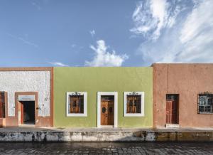 a colorful building with doors and windows on a street at Luxury Suite by La Casa Verde in Campeche