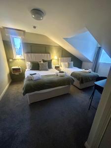 a bedroom with two beds and a window at The Boutique Bungalow in Bundoran