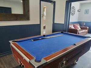 a pool table sitting in a living room with at Beachside 1 in Saint Helier Jersey