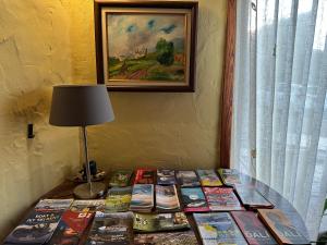 a table with books on it with a lamp on it at Can Genis Turismo Rural in Peralada