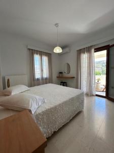 a bedroom with a large bed and a large window at Villa Elia in Mélanes +96 photos