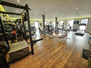 a gym with treadmills and exercise bikes in a room at Hotel Seeblick in Bad Reichenhall