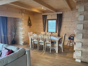 a dining room with a table and chairs at Cicha Ostoja in Czarny Dunajec