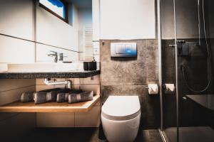 a bathroom with a toilet and a sink at Pension Kuntschner in Mittersill +24 photos