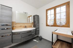 a bathroom with a sink and a mirror at Gîte À la Bonne Compagnie in Preures +51 photos