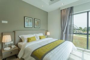 a bedroom with a bed and a large window at Meru Suites at Meru Valley Resort in Ipoh