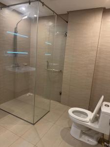 a bathroom with a glass shower and a toilet at The Cubee Nest- Luxury 1BHK in Central Bahria Enclave in Islamabad +8 photos