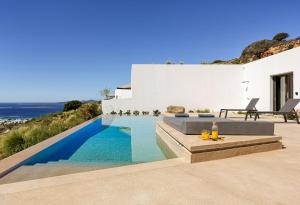 a swimming pool in a villa with a view of the ocean at Skylines Estate Paros in Kampos Paros