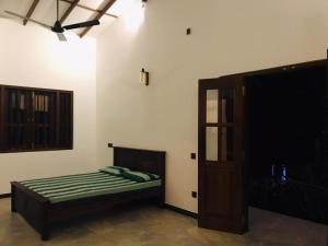 a bedroom with a bed and a door in a room at RailNest in Talpe