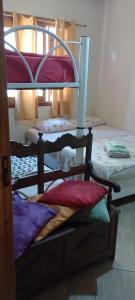 a room with three bunk beds in a room at Pousada Nilda in Pântano Grande