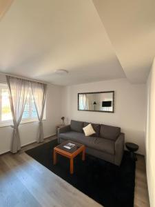 a living room with a couch and a table at Al Pozz Boutique Resort in Locarno