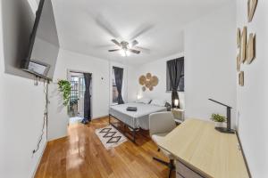 a white room with a bed and a desk at Double Room with shared bathroom in Times Square in New York