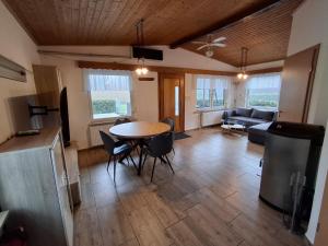 a living room with a table and chairs and a couch at Ferienhaus am Mittelberg in Nordhausen +19 photos