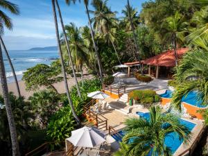 an aerial view of a resort with a swimming pool and the beach at Tango Mar Beachfront Boutique Hotel & Villas in Tambor