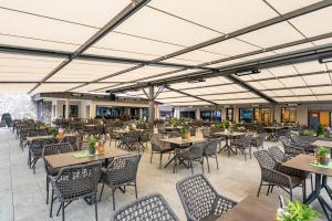 an empty dining area with tables and chairs at Hotel Berghof Mayrhofen in Mayrhofen