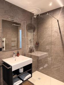 a bathroom with a sink and a glass shower at Al Pozz Boutique Resort in Locarno +83 photos