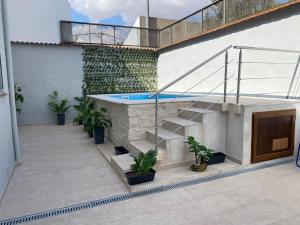 a patio with a swimming pool and stairs and plants at Los Henares 3 in Olombrada