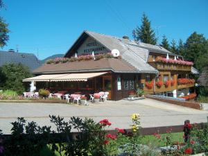 a restaurant with tables and chairs in front of it at Hotel Bären - drei Sterne in Bernau im Schwarzwald