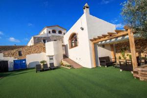 a house with a yard with green grass at Catalunya Casas Captivating Villa in the Vineyard close to Sitges in Bisbal del Penedès