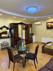 a living room with a glass table and chairs at Готель Козацький in Zvenyhorodka